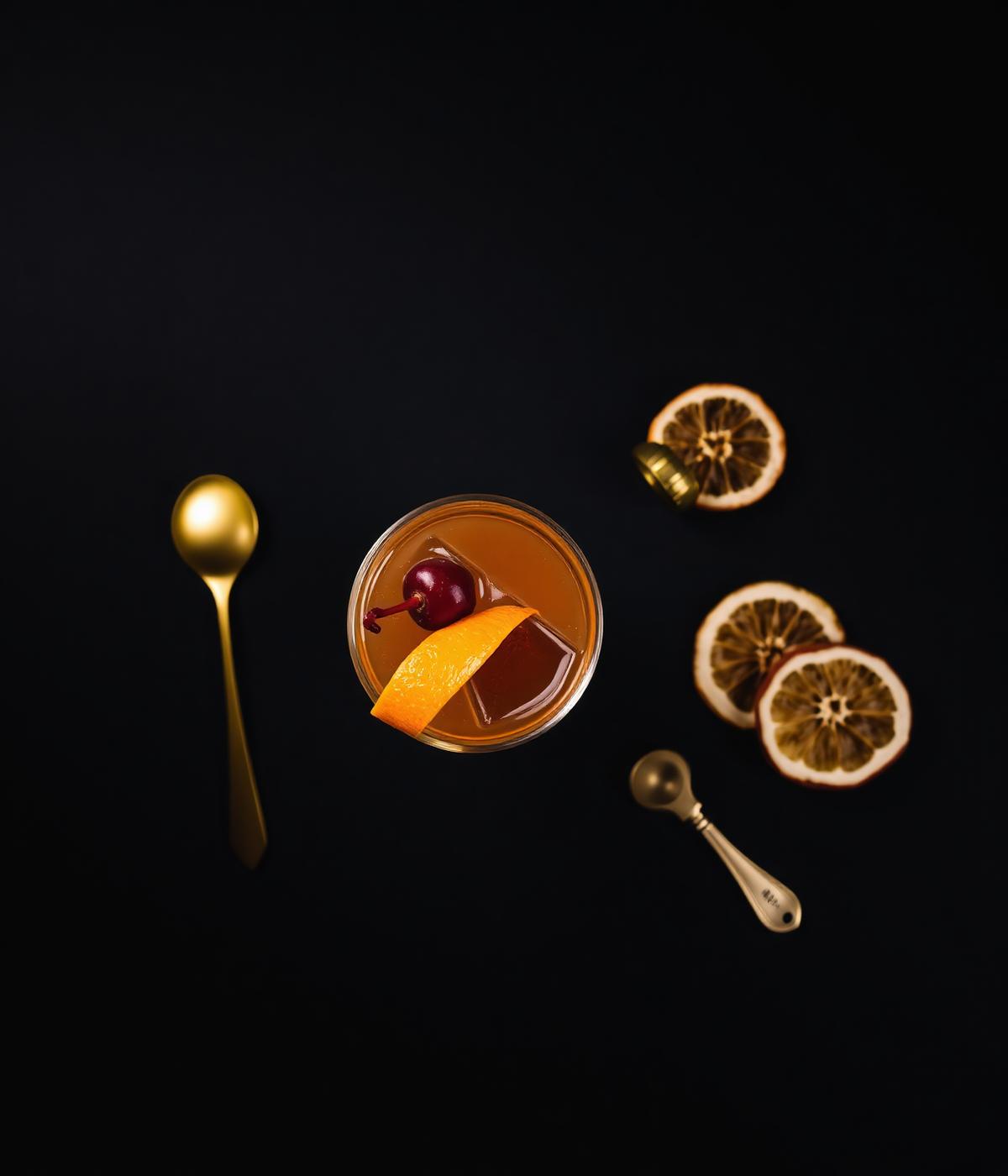 Signature old fashioned with orange peel and brandied cherry